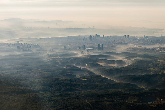 Istanbul Morning  A panoramic morning cityscape with modern buildings rising through a thick, atmospheric haze