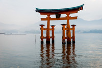 Itsukushima Miyajima: The iconic orange Torii gate of Miyajima stands peacefully in the calm sea