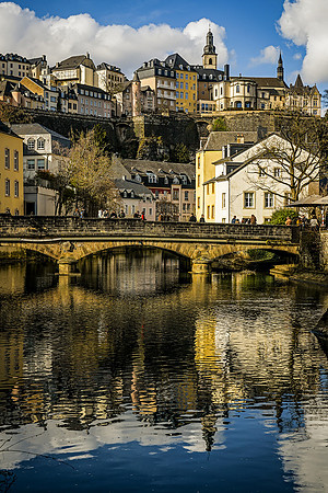 Luxembourg Grund Spring: The ancient stone arches and river of the Grund captured in bright spring light