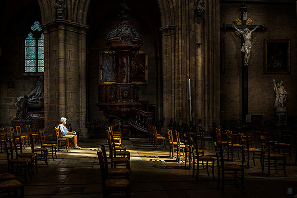 Dijon: A dramatic interior of a Dijon cathedral, focusing on the play of light and shadow