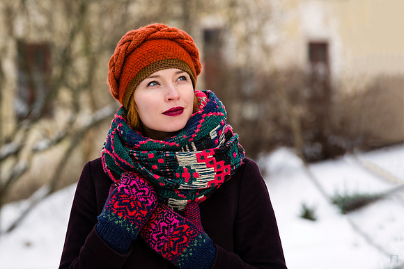 Outdoor winter portrait of Viltaute wearing a red hat and a vibrant patterned scarf