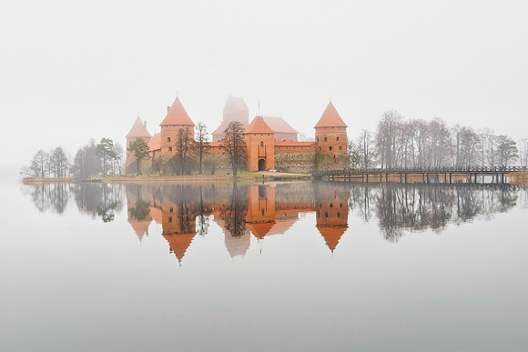 Trakai Castle Symmetrical reflection of the historic  Island Castle on a mirror-like, still and foggy lake