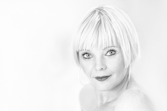 High-key black and white close-up portrait of Steffi featuring soft lighting and minimalist aesthetic
