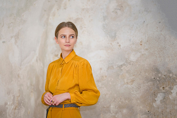 Cinematic environmental portrait of Ruta in a textured, rustic interior